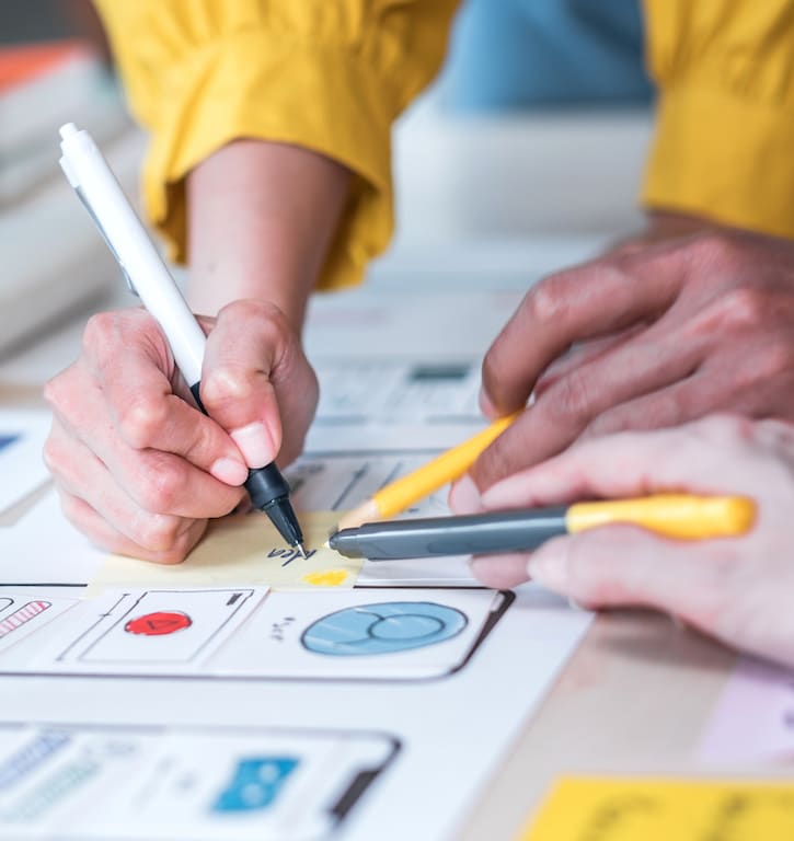 collaboration in a vibrant workspace with mock-ups, sketches, and dynamic design brainstorming.