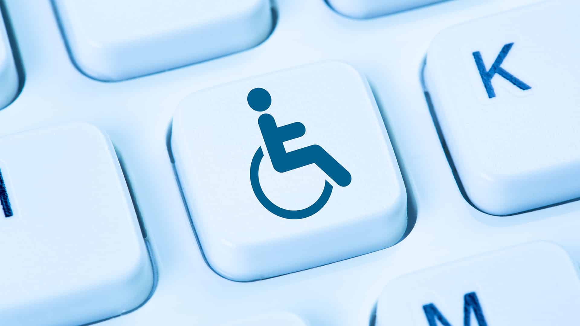 accessibility key on keyboard featuring blue wheelchair icon for inclusivity and user-friendly design.