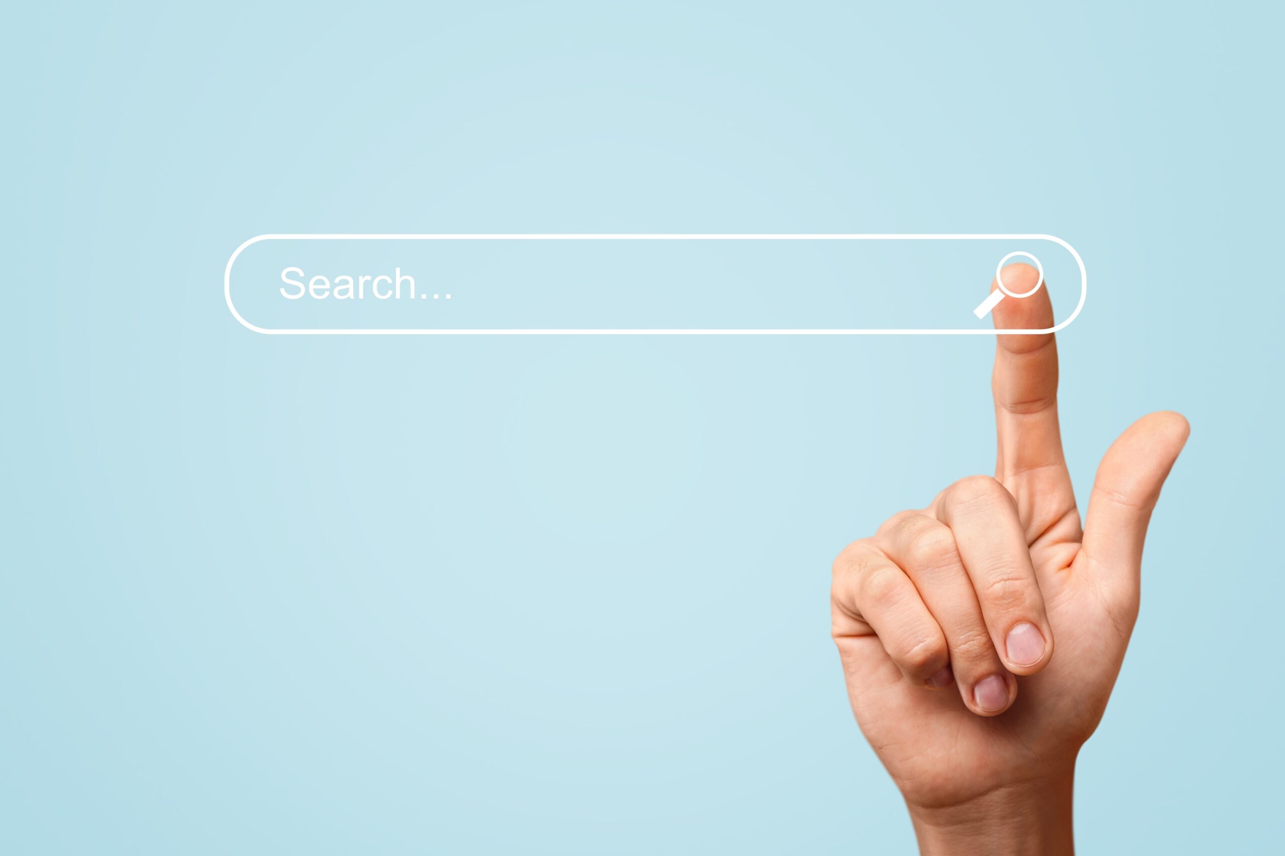 mans hand reaching for search bar, symbolizing the ease of online information access.